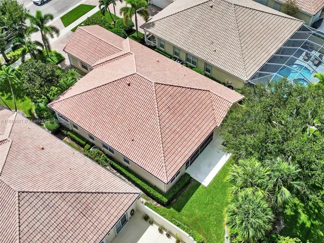 an aerial view of a house with a yard