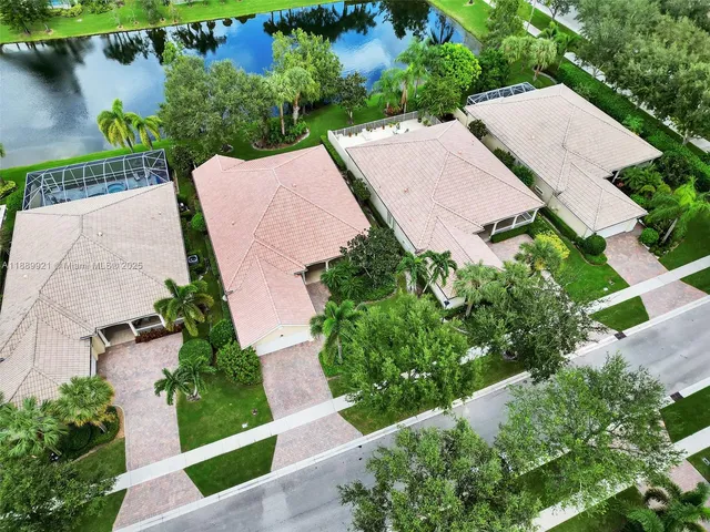 an aerial view of a house with outdoor space and lake view