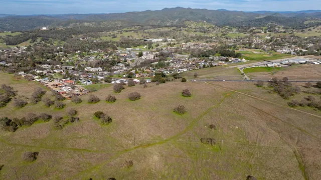a view of a yard with wooden fence