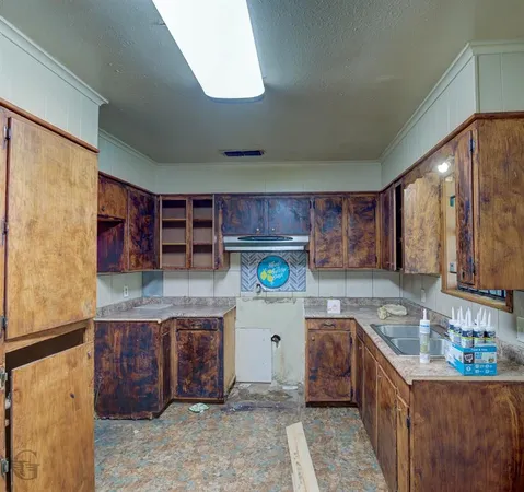 a kitchen with stainless steel appliances granite countertop a sink and a stove
