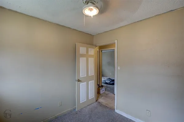 an empty room with a mirror