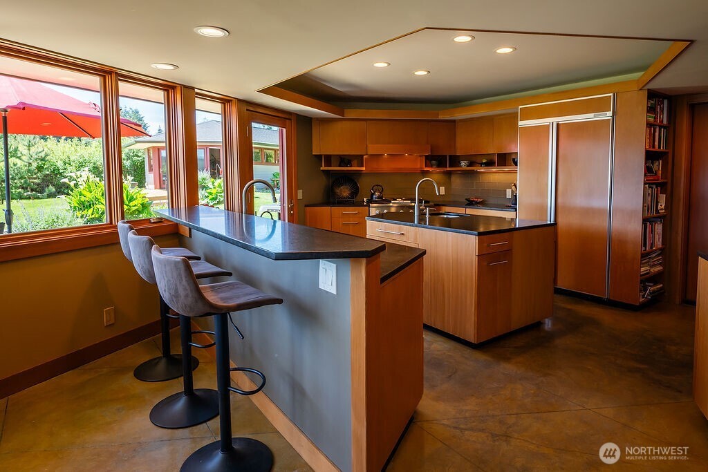 2000 Bayshore Road Lopez Island, WA 98261 - Photo 8 of 40 a kitchen with stainless steel appliances granite countertop sink window and chairs