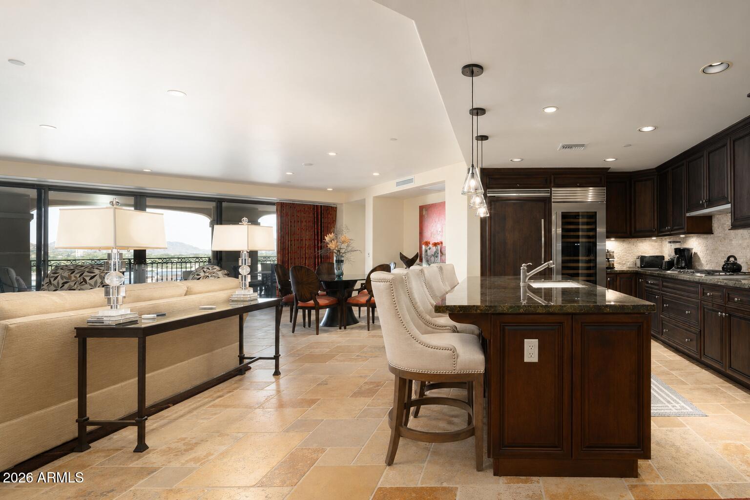 7181 East Camelback Road, Unit 1001 Scottsdale, AZ 85251 - Photo 1 of 34 a kitchen with a sink and chairs