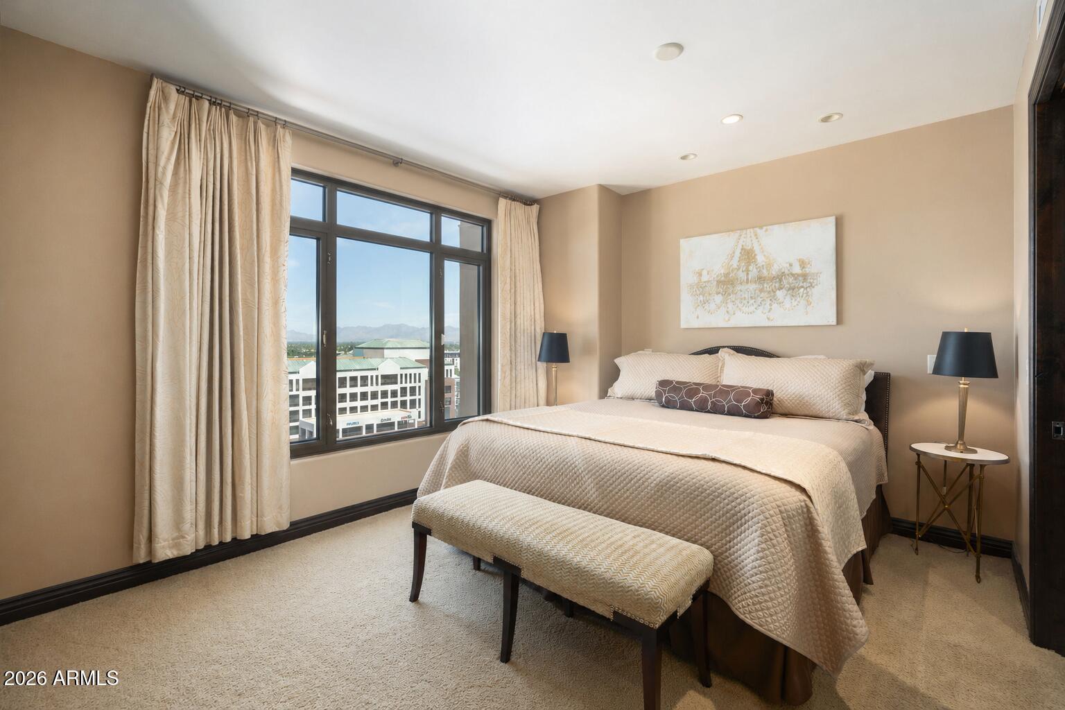 7181 East Camelback Road, Unit 1001 Scottsdale, AZ 85251 - Photo 13 of 34 a bedroom with a bed and a couch
