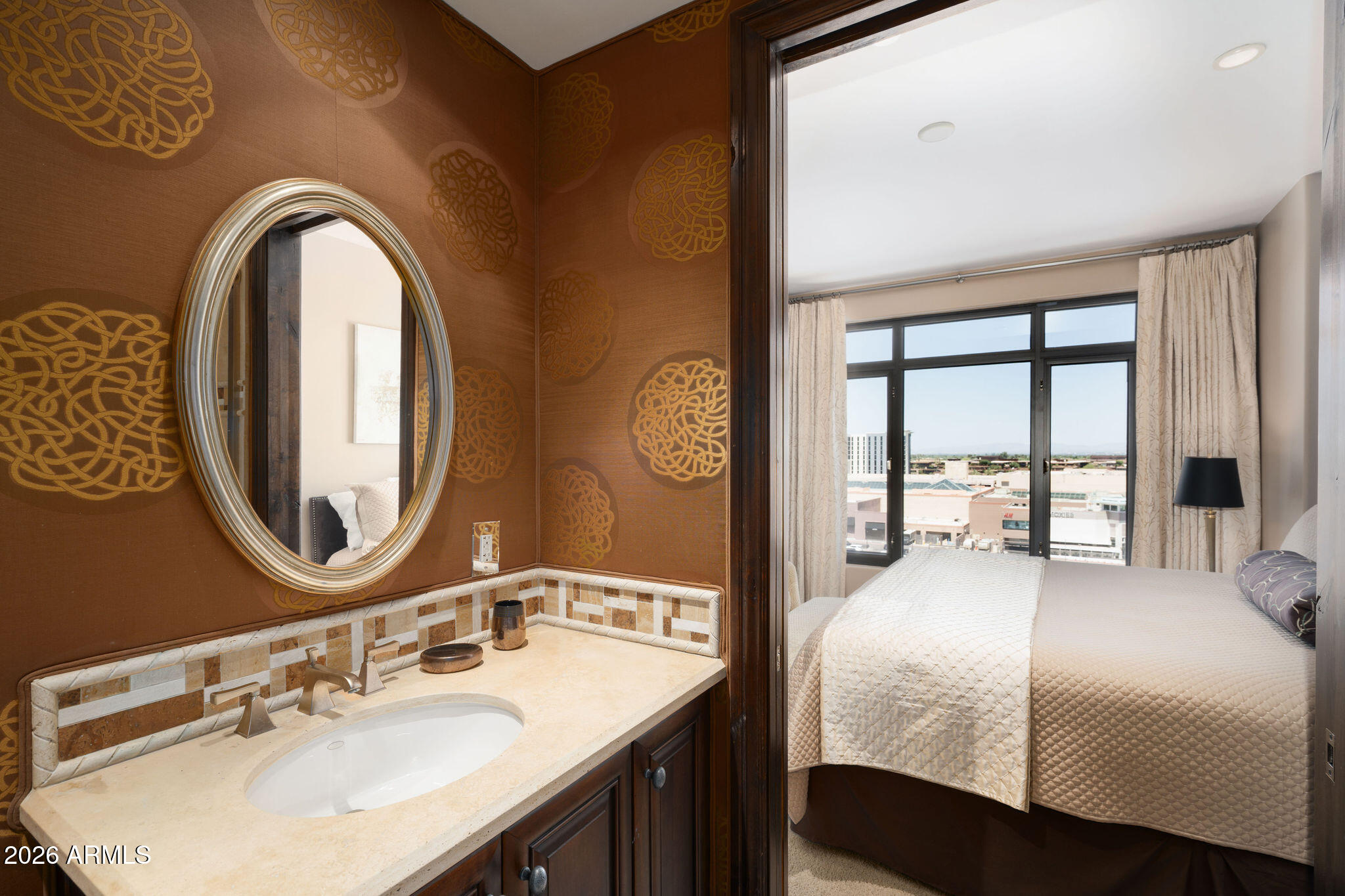 7181 East Camelback Road, Unit 1001 Scottsdale, AZ 85251 - Photo 15 of 34 a bedroom with a bed and a mirror