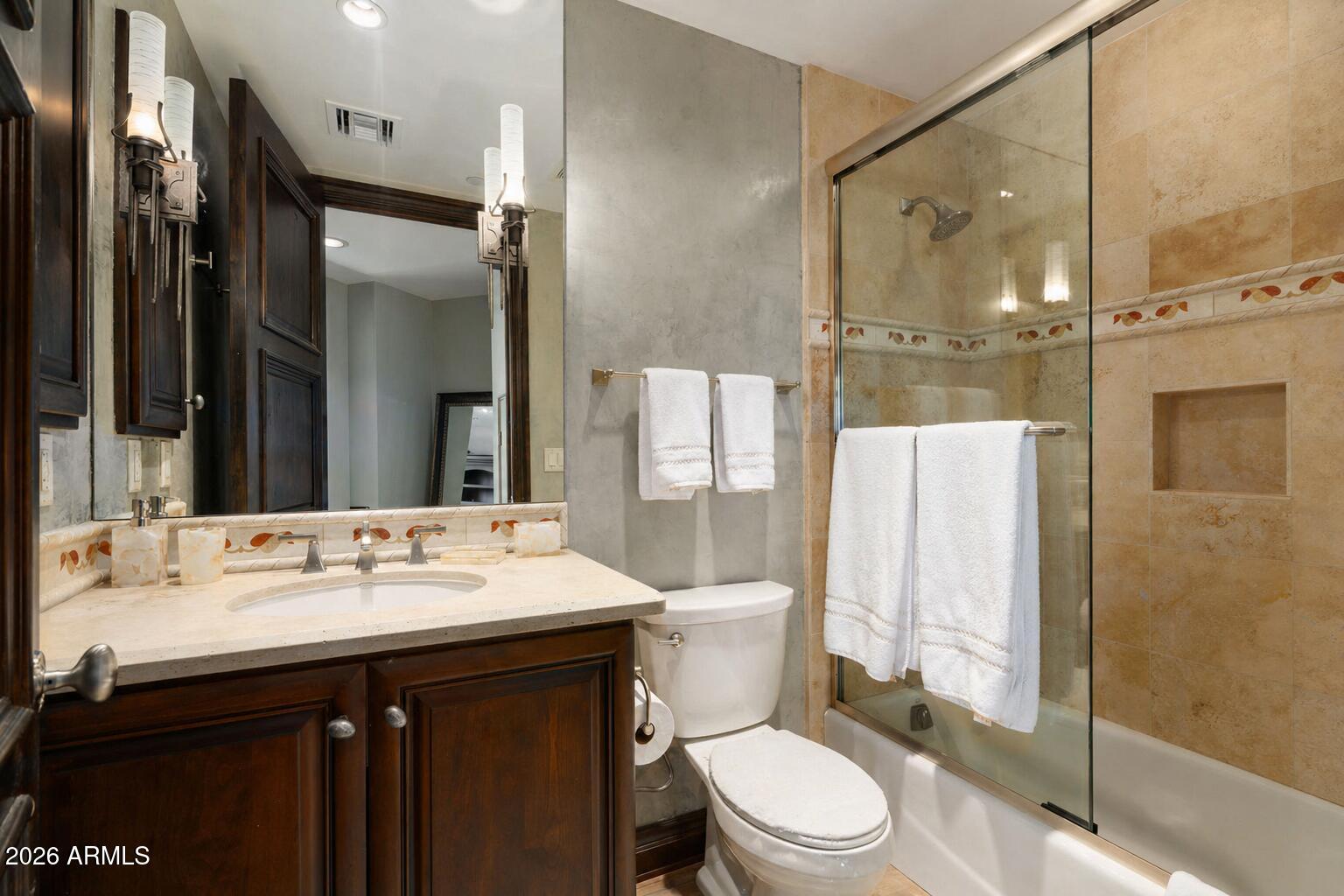 7181 East Camelback Road, Unit 1001 Scottsdale, AZ 85251 - Photo 19 of 34 a bathroom with a sink vanity mirror and toilet