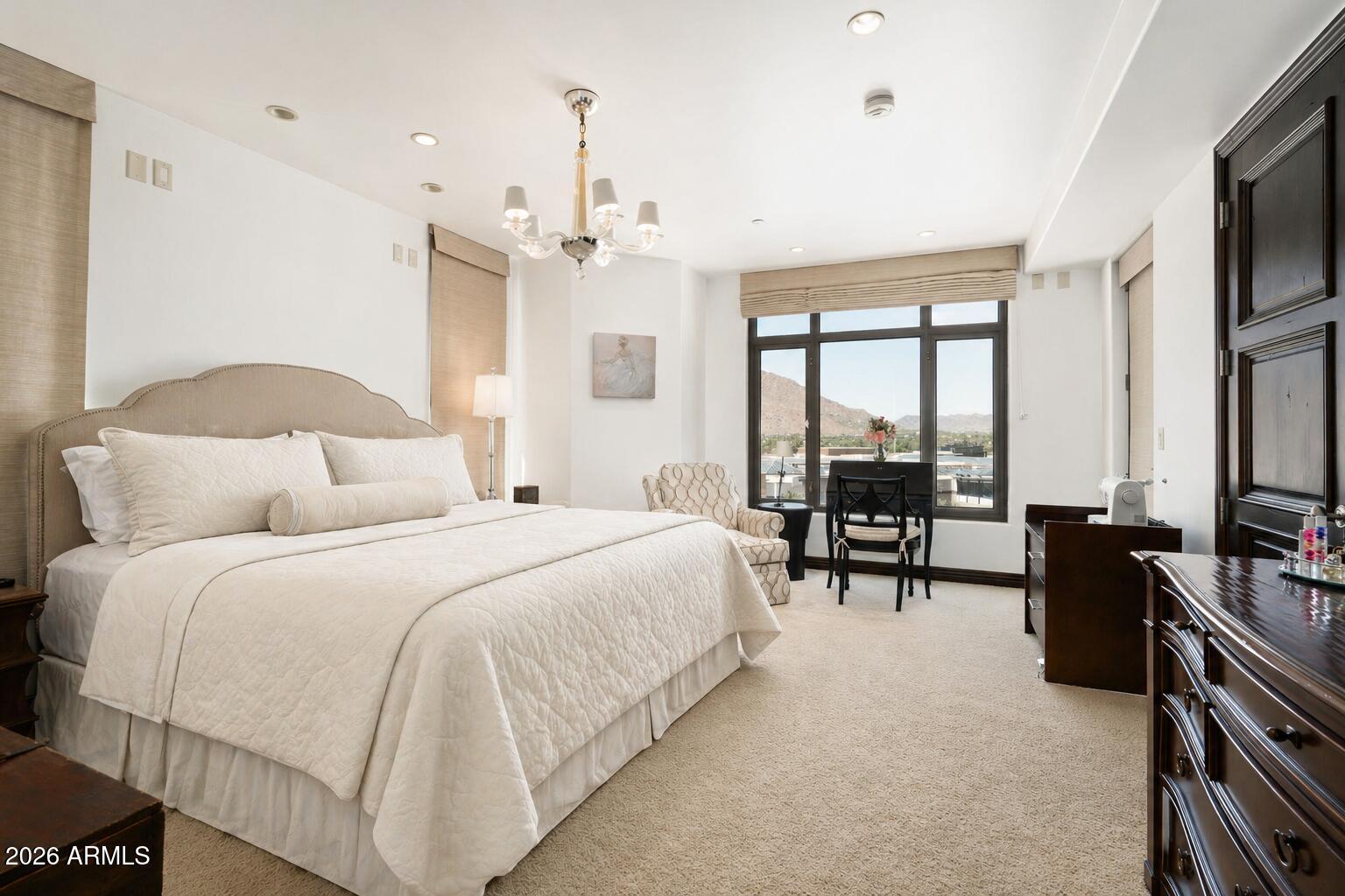 7181 East Camelback Road, Unit 1001 Scottsdale, AZ 85251 - Photo 20 of 34 a spacious bedroom with a bed a large window and a flat tv screen