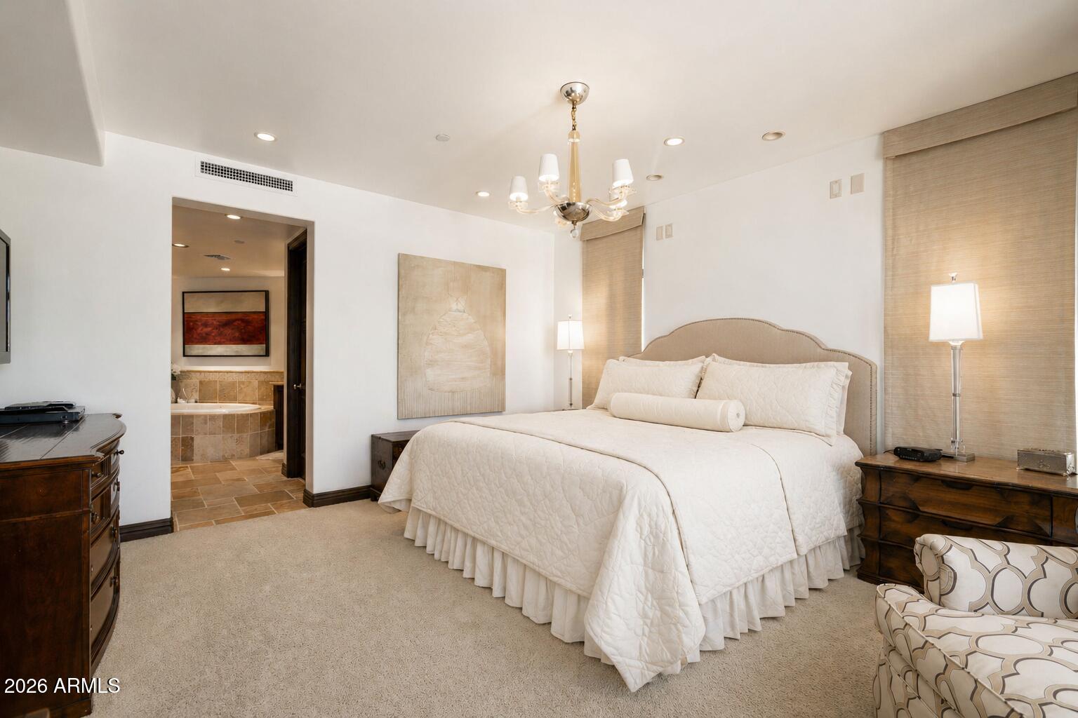7181 East Camelback Road, Unit 1001 Scottsdale, AZ 85251 - Photo 22 of 34 a bedroom with a bed and a walk in closet