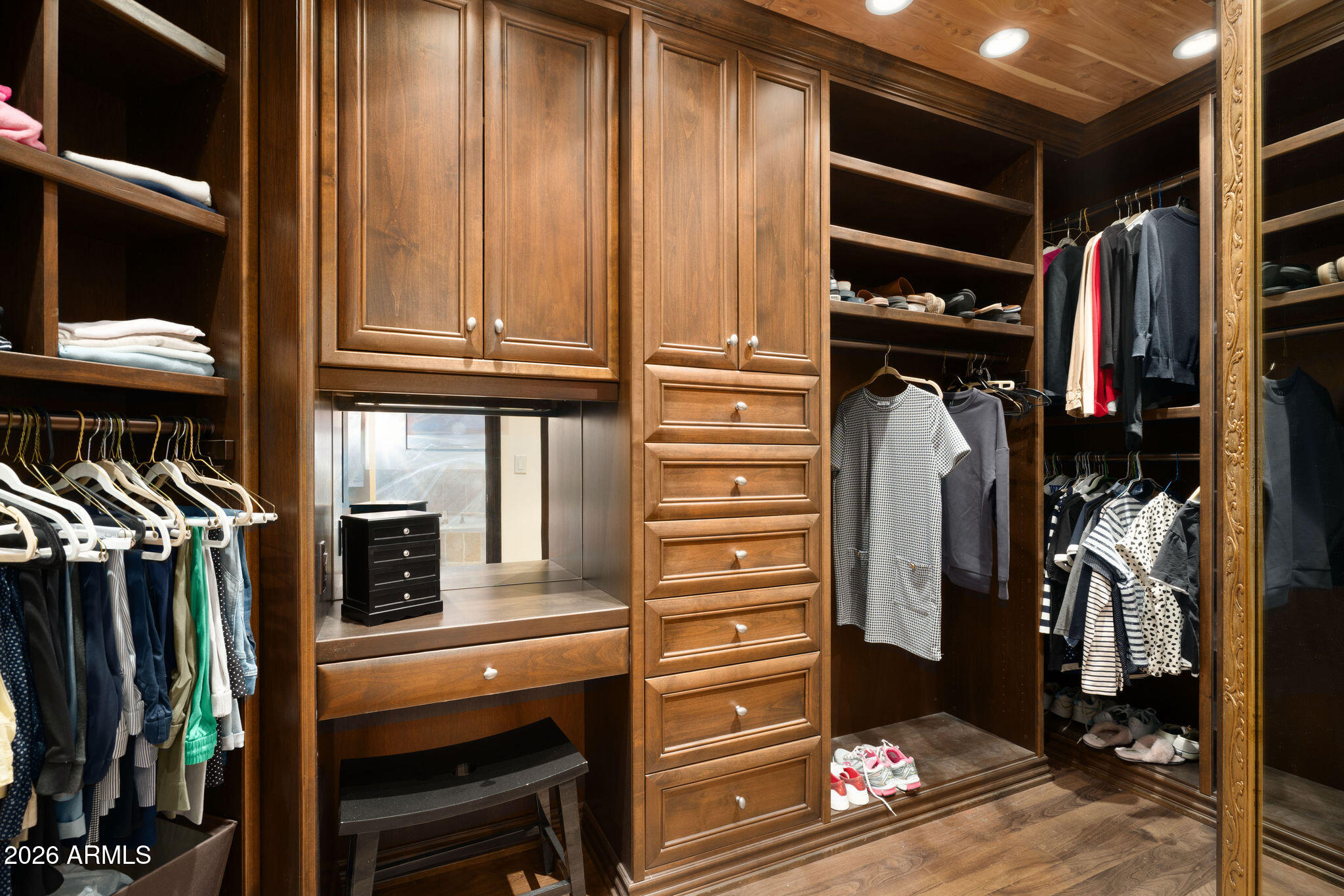 7181 East Camelback Road, Unit 1001 Scottsdale, AZ 85251 - Photo 25 of 34 a view of walk in closet with clothes and shoes