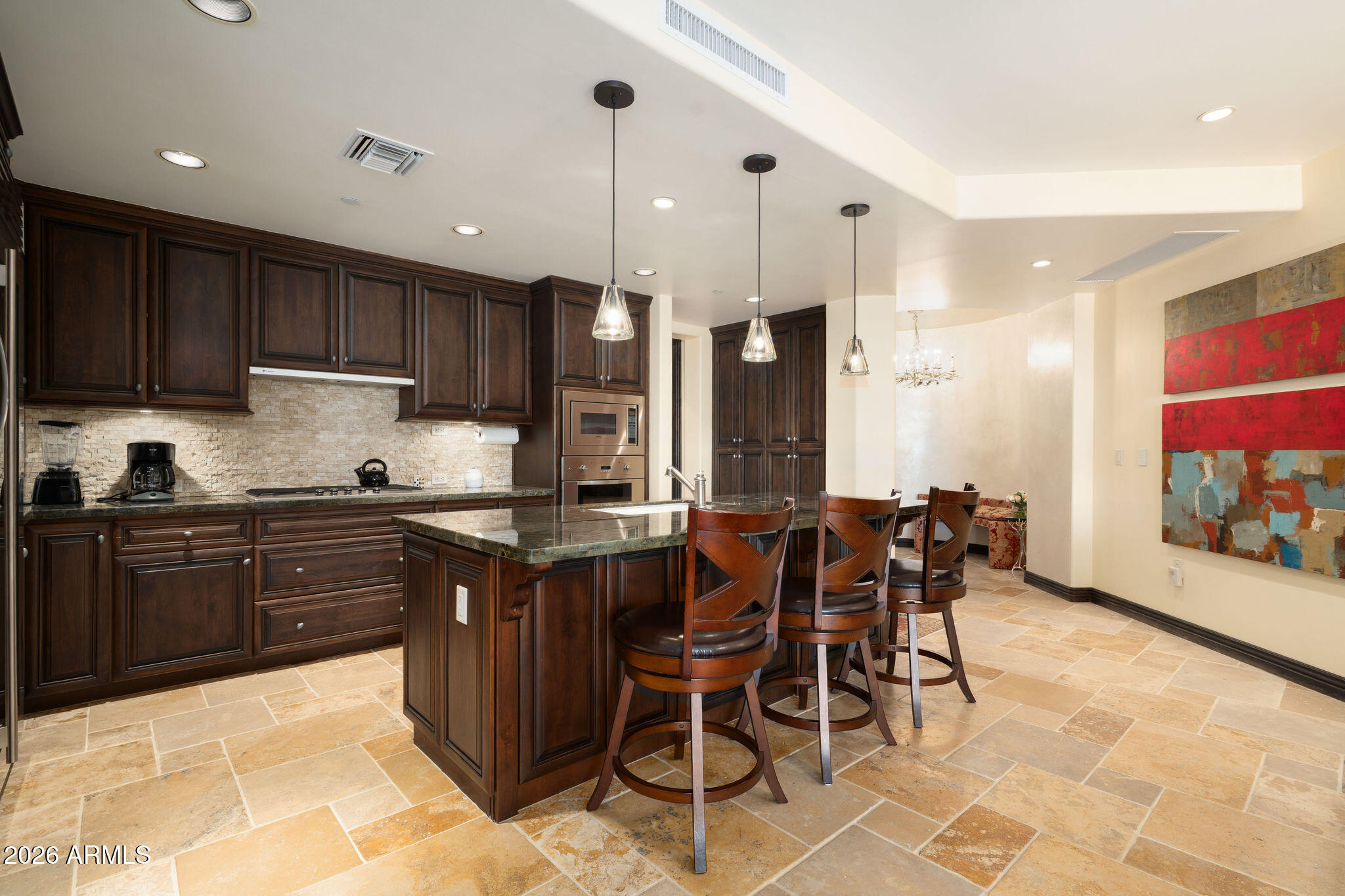 7181 East Camelback Road, Unit 1001 Scottsdale, AZ 85251 - Photo 3 of 34 a kitchen with stainless steel appliances granite countertop wooden cabinets a refrigerator and sink
