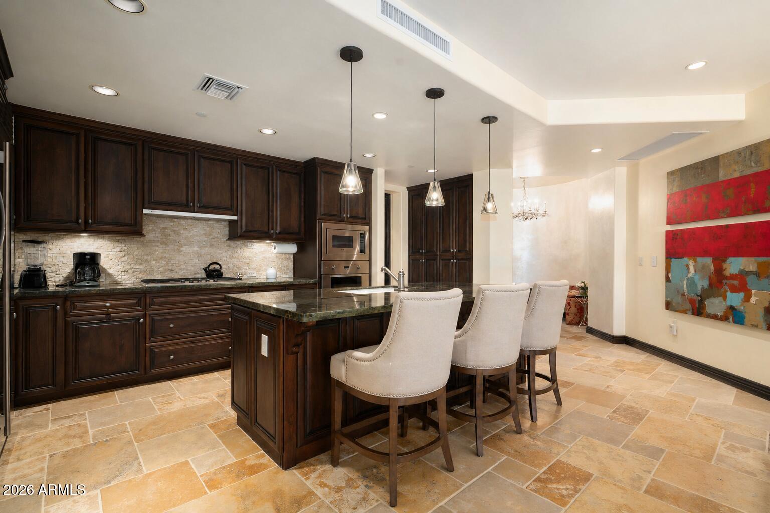 7181 East Camelback Road, Unit 1001 Scottsdale, AZ 85251 - Photo 34 of 34 a kitchen with a sink cabinets and wooden floor