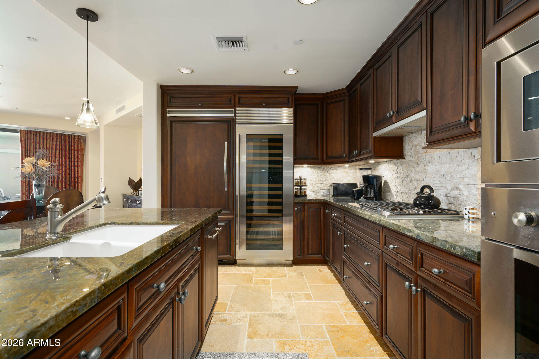 7181 East Camelback Road, Unit 1001 Scottsdale, AZ 85251 - Photo 4 of 34 a large kitchen with granite countertop a sink and dishwasher a stove top oven with wooden floor