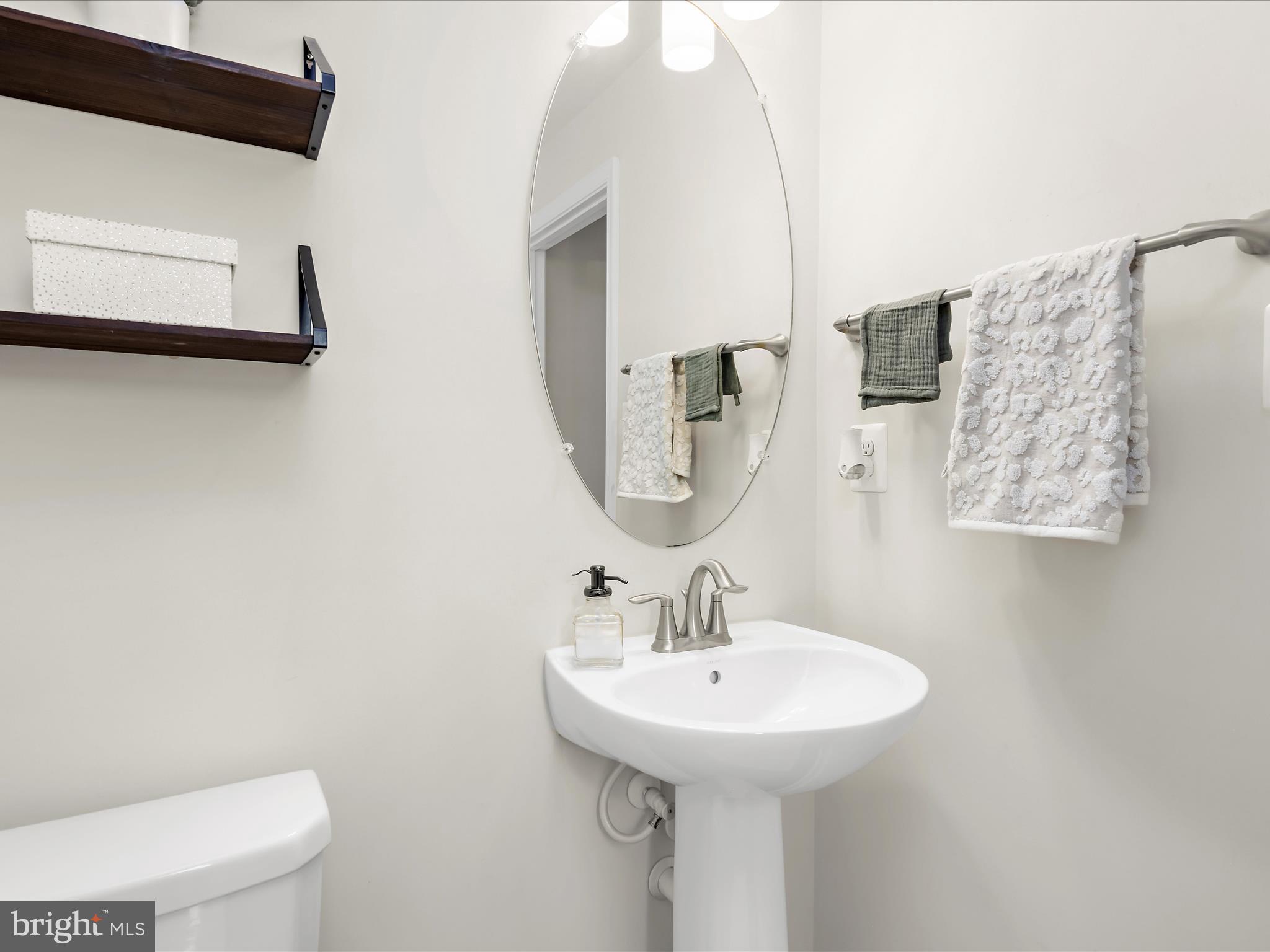 1239 Orchid Road Gambrills, MD 21054 - Photo 12 of 58 a bathroom with a toilet sink and mirror