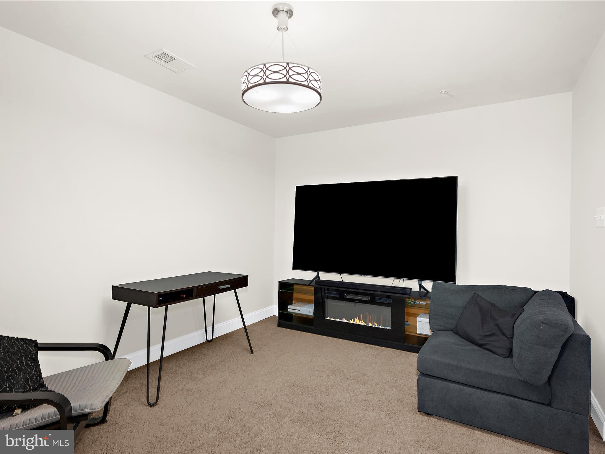 1239 Orchid Road Gambrills, MD 21054 - Photo 25 of 58 a living room with furniture and a flat screen tv