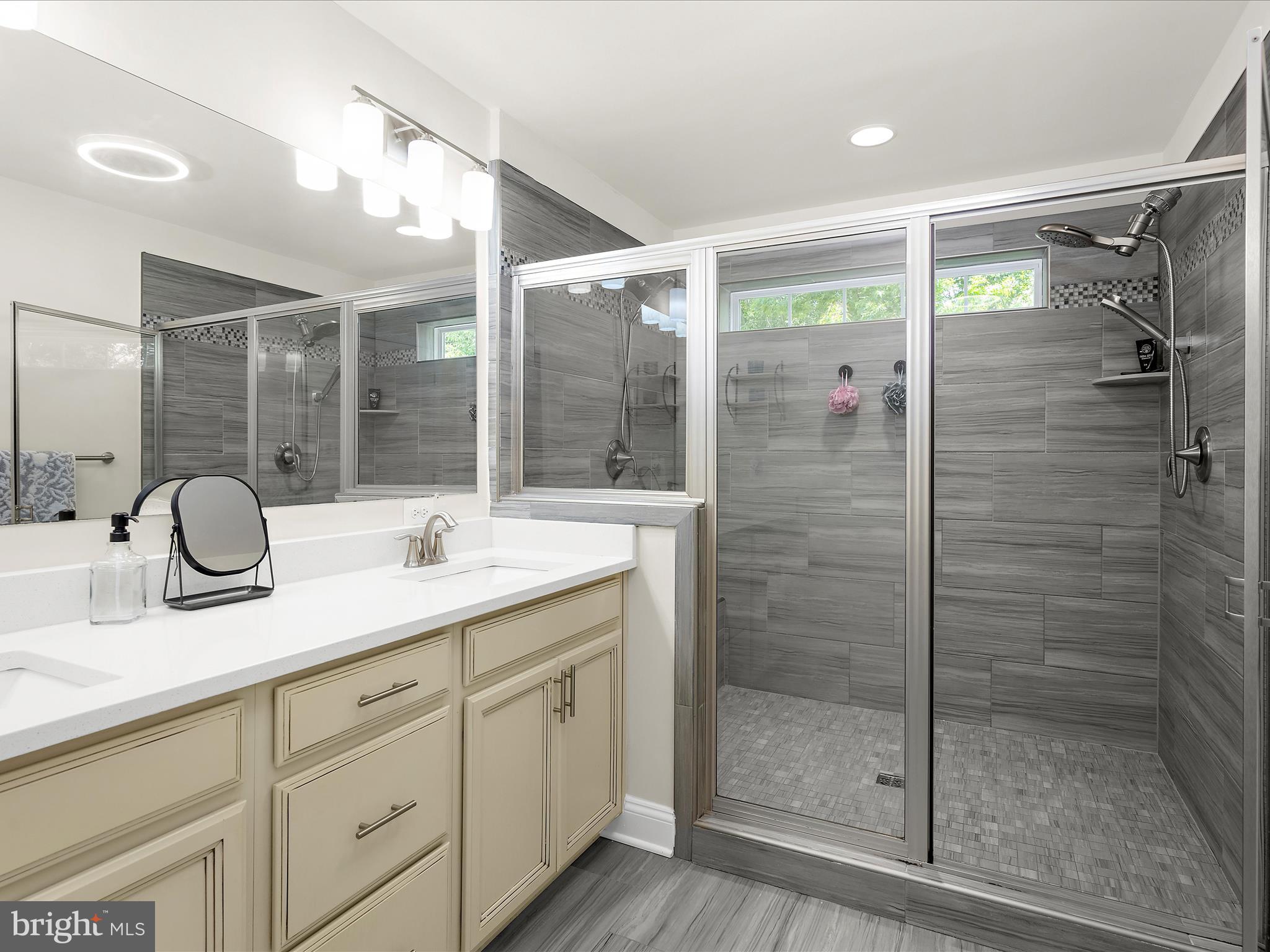 1239 Orchid Road Gambrills, MD 21054 - Photo 27 of 58 a bathroom with a shower sink and mirror