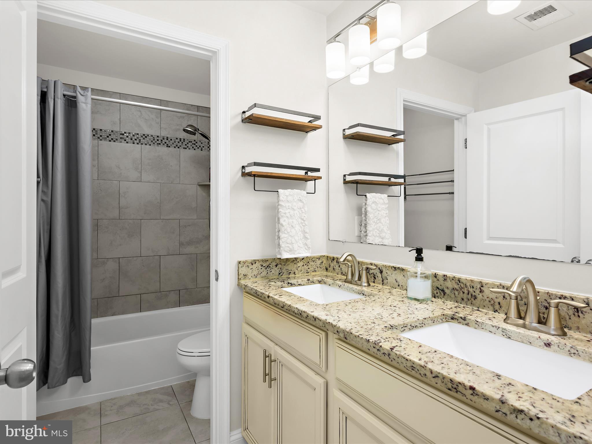 1239 Orchid Road Gambrills, MD 21054 - Photo 30 of 58 a bathroom with a granite countertop sink mirror vanity and toilet
