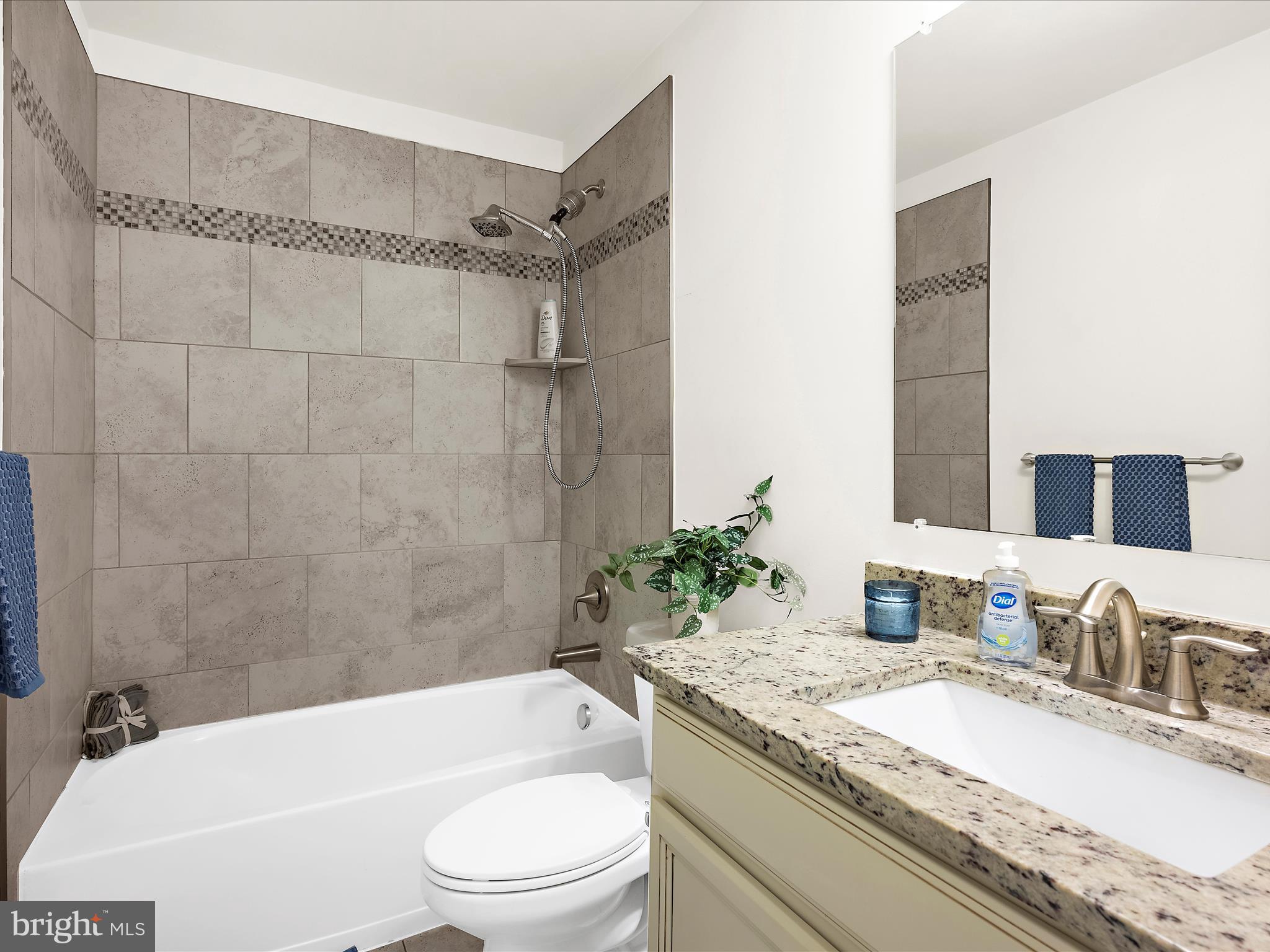1239 Orchid Road Gambrills, MD 21054 - Photo 31 of 58 a bathroom with a granite countertop bathtub shower sink vanity mirror and toilet