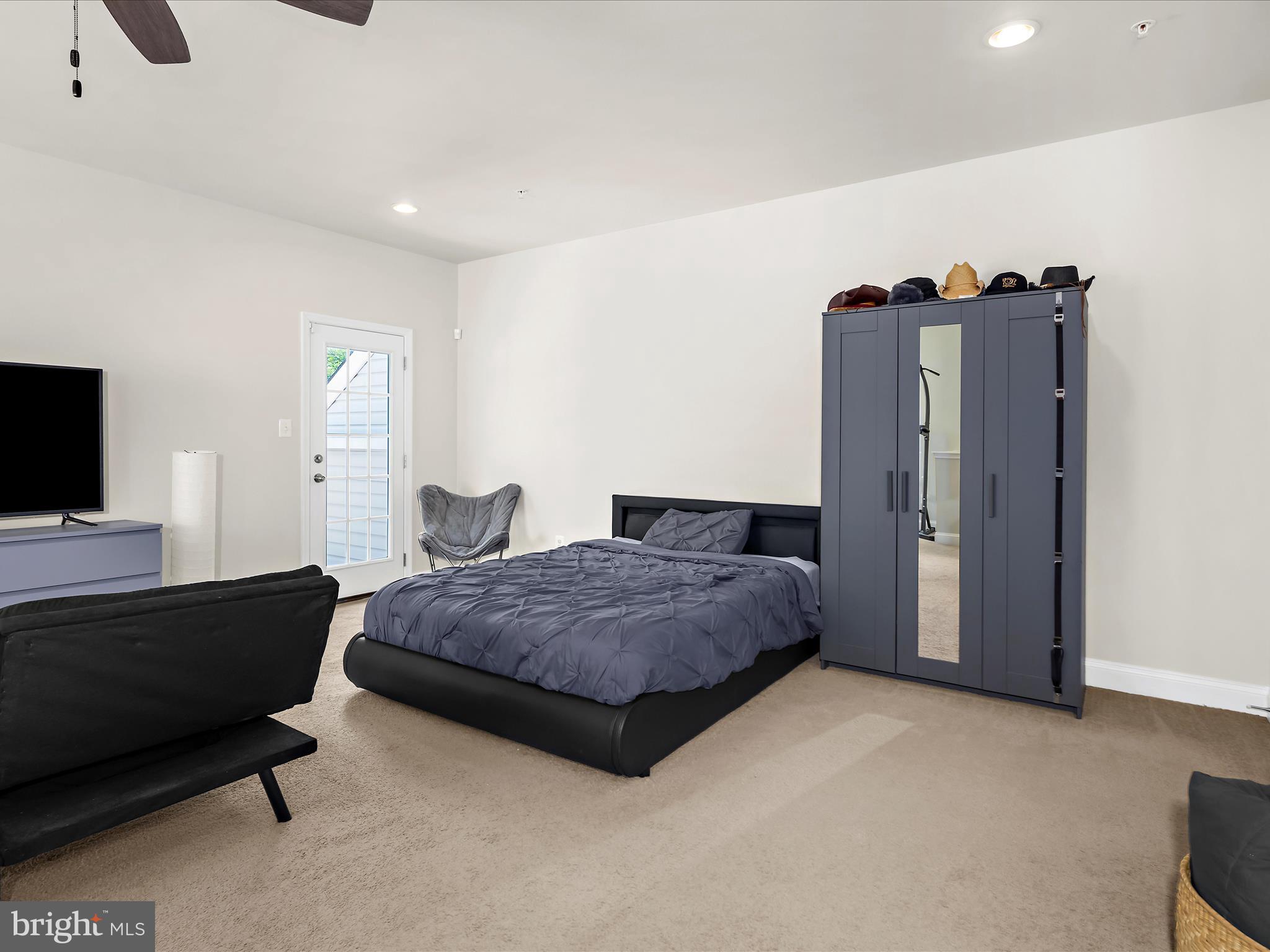 1239 Orchid Road Gambrills, MD 21054 - Photo 33 of 58 a spacious bedroom with a bed and a television