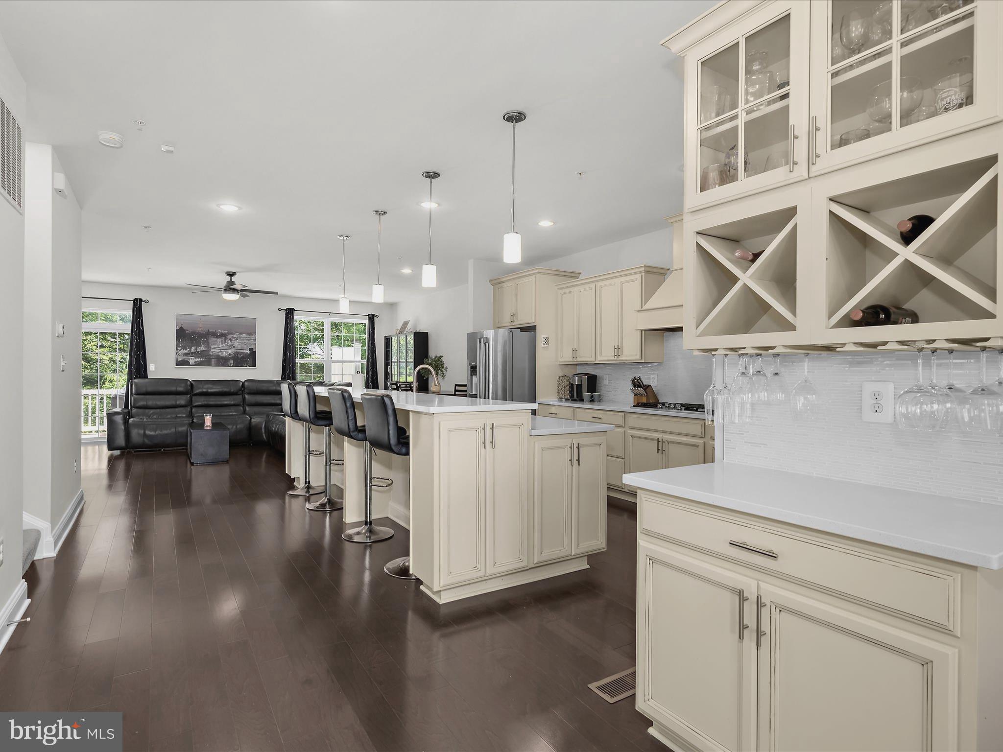 1239 Orchid Road Gambrills, MD 21054 - Photo 5 of 58 a kitchen with a white cabinets and chairs