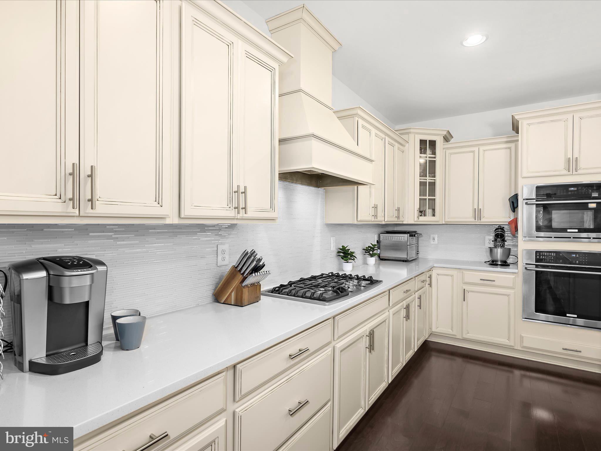 1239 Orchid Road Gambrills, MD 21054 - Photo 6 of 58 a kitchen with stainless steel appliances granite countertop a stove a sink and white cabinets