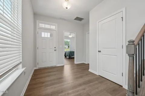 a view of a hallway with wooden floor