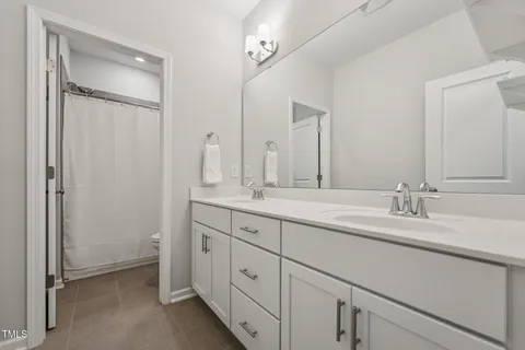 a bedroom with a bed and a ceiling fan