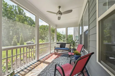 a view of a house with a yard and potted plants