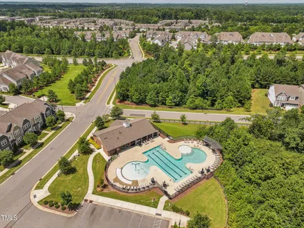 a aerial view of a house with garden space and swimming pool