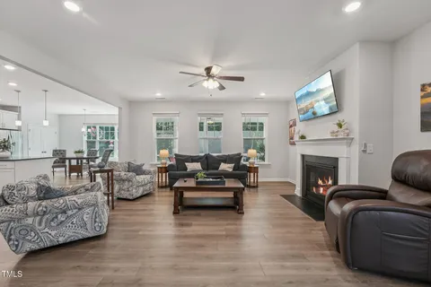 a living room with furniture a fireplace and a flat screen tv