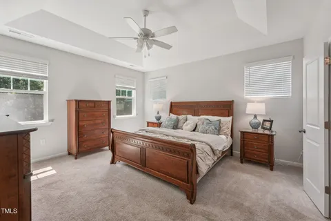 a spacious bedroom with a bed and a chandelier