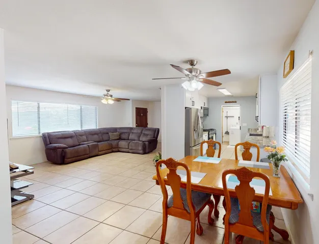 a view of a dining room with furniture and a chandelier
