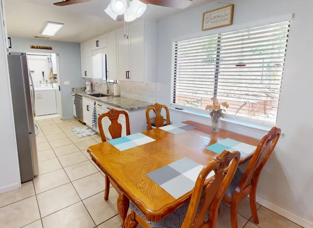 a view of kitchen with dining table and chairs