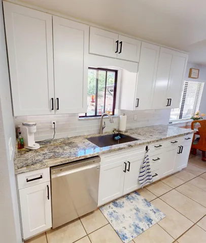 a kitchen with stainless steel appliances granite countertop a sink stove and cabinets
