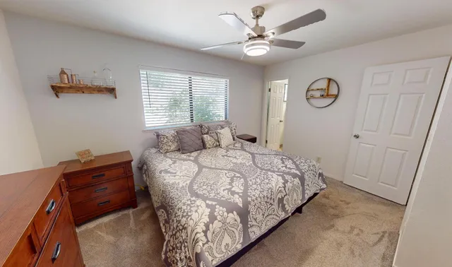 a bedroom with a bed and a window