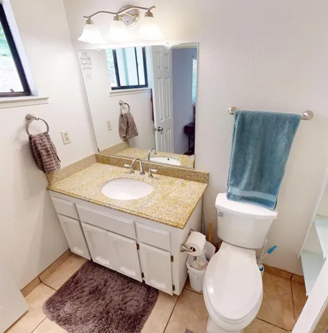 a bathroom with a sink toilet and mirror