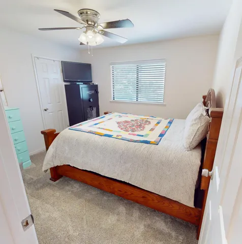 a bedroom with a bed and a chandelier