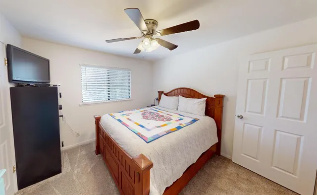 a bedroom with bed and window