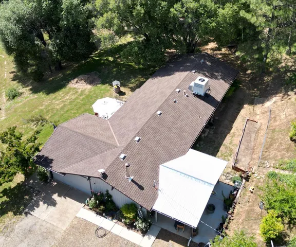 an aerial view of a house with a yard