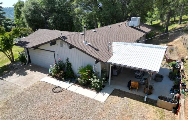 a view of a house with yard and sitting area