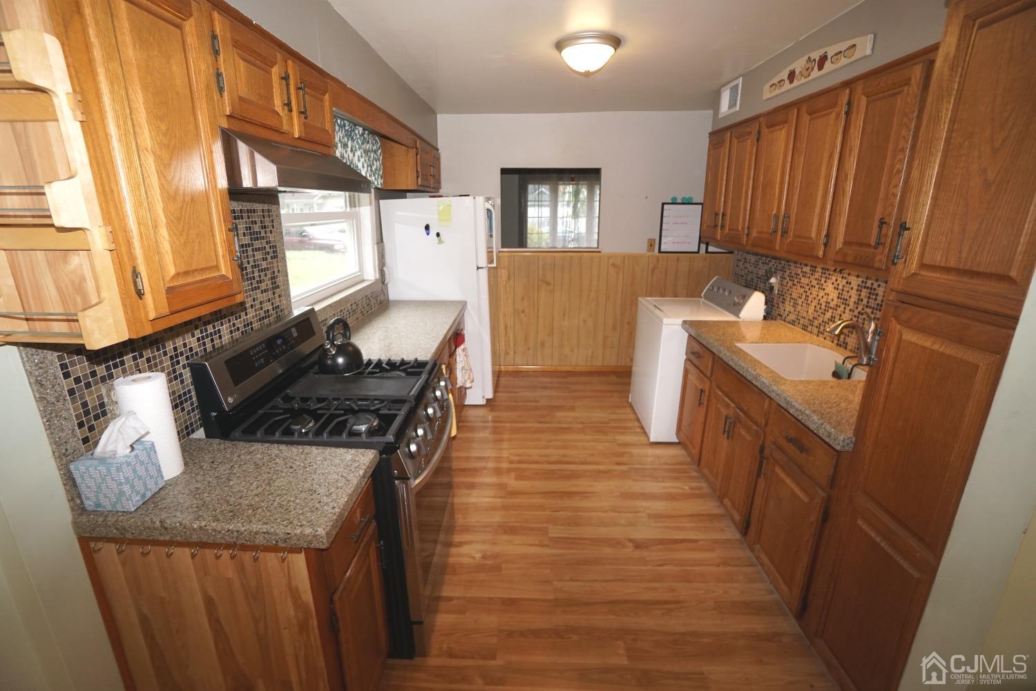 4 Piedmont Road Edison, NJ 08817 - Photo 7 of 22 a kitchen with a stove and a refrigerator
