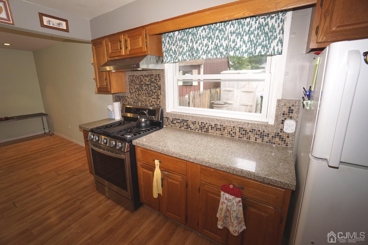 4 Piedmont Road Edison, NJ 08817 - Photo 9 of 22 a kitchen with granite countertop a stove and a refrigerator
