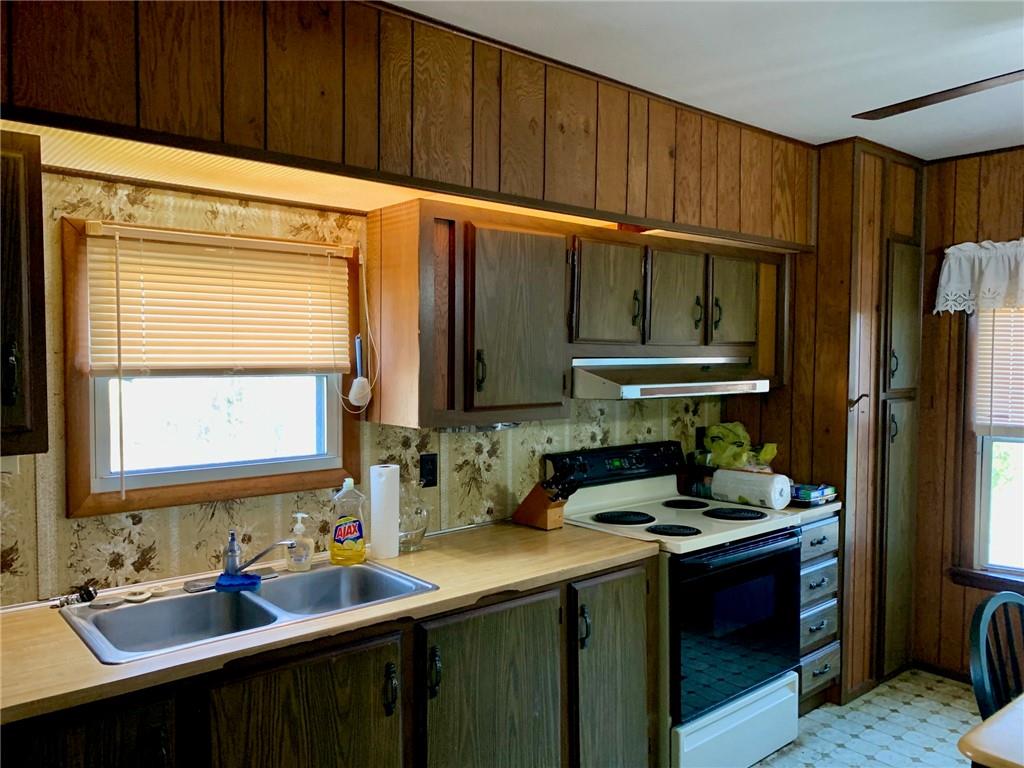 239 Crystal Spring Road Sandy Lake, PA 16145 - Photo 13 of 40 a kitchen with a sink refrigerator and cabinets