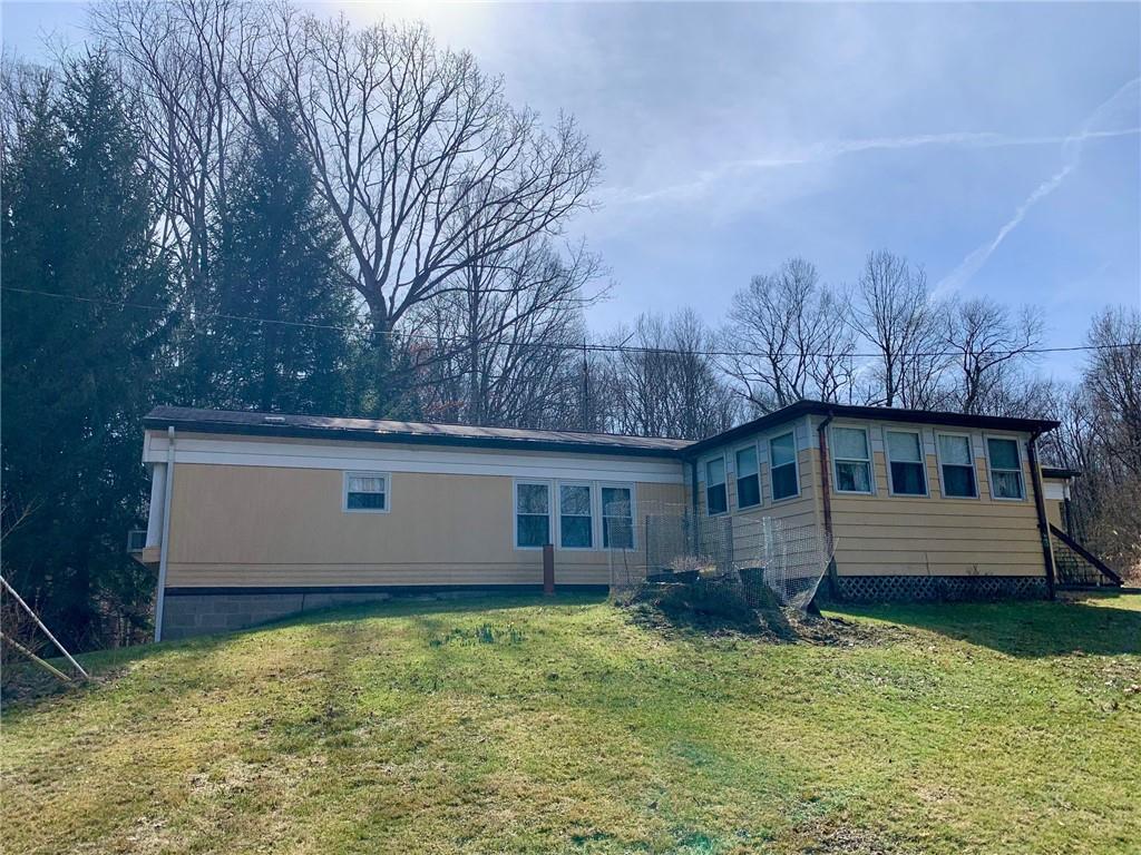 239 Crystal Spring Road Sandy Lake, PA 16145 - Photo 2 of 40 a backyard of a house with lots of green space