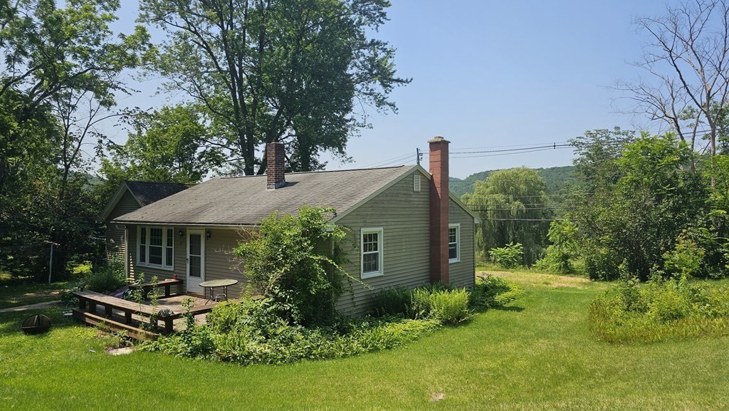 34 High Road Hardwick, MA 01031 - Photo 2 of 29 a front view of a house with a yard table and chairs