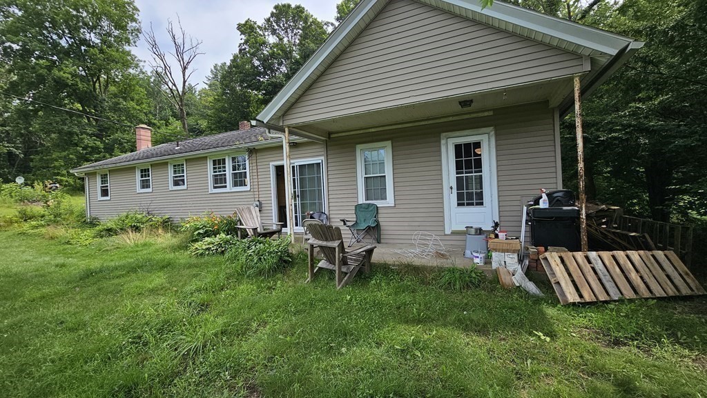 34 High Road Hardwick, MA 01031 - Photo 25 of 29 a view of a house with a backyard and a patio