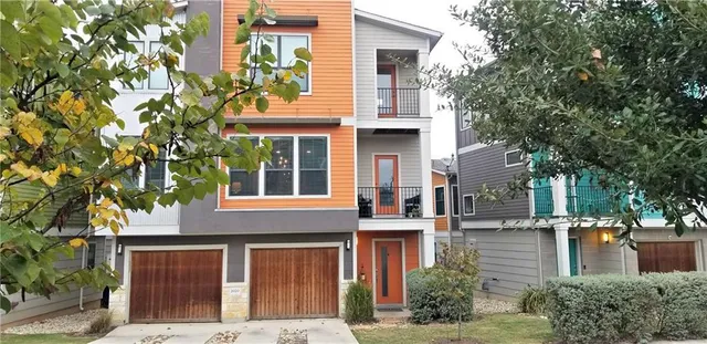 a front view of a building with a garden