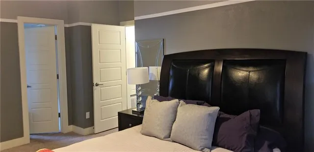 a living room with a couch and a refrigerator