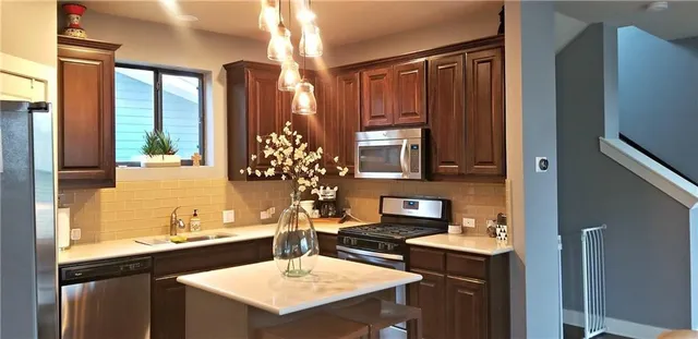 a kitchen with a sink and a refrigerator