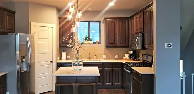 a bathroom with a sink vanity granite tub shower and a mirror