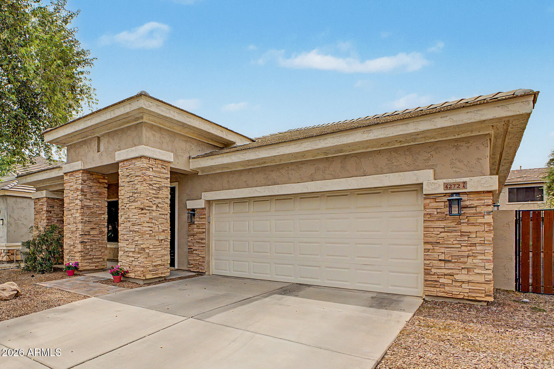 4272 East Buckboard Road Gilbert, AZ 85297 - Photo 6 of 37 a front view of a house with garage